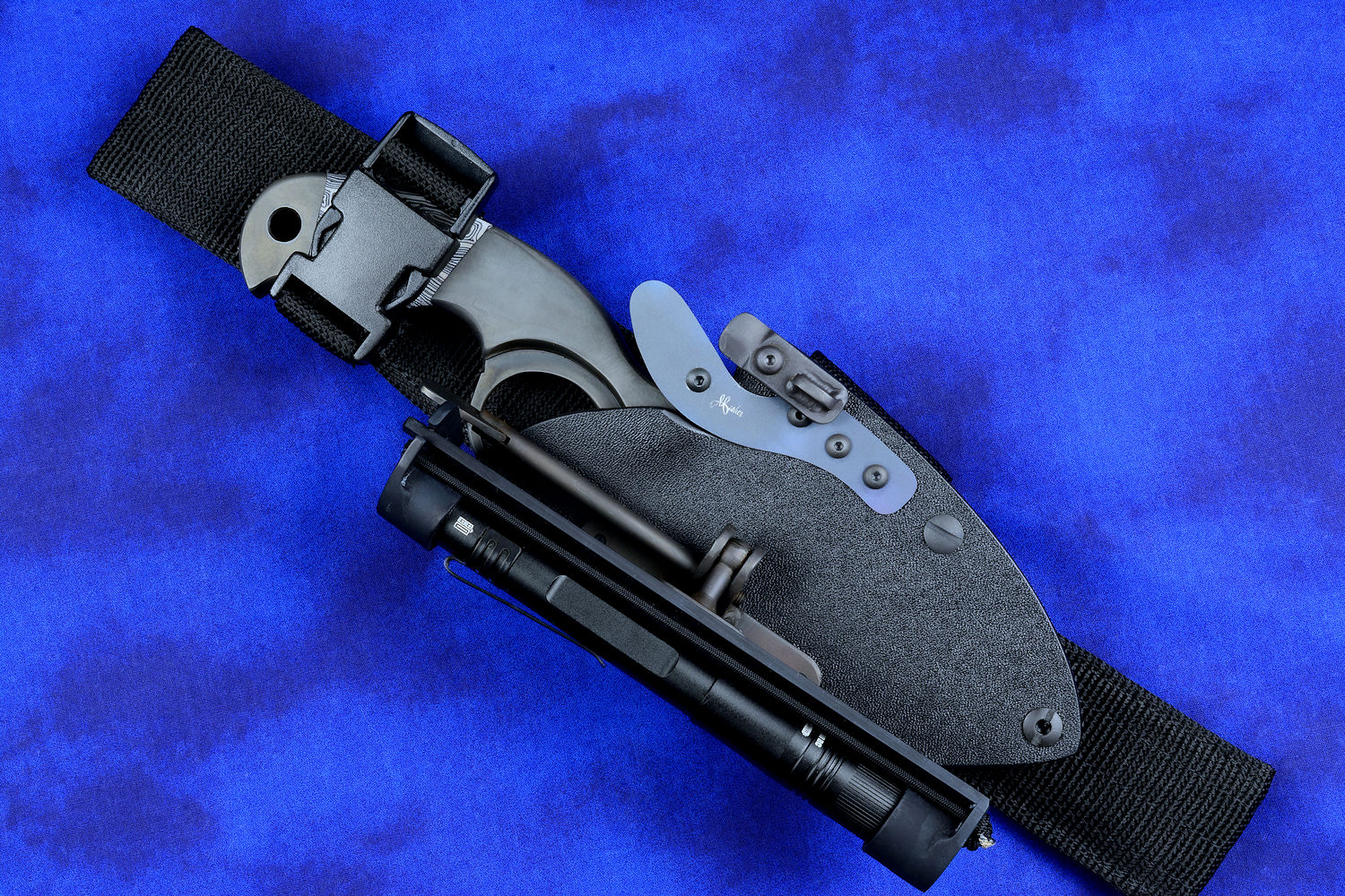 "Skeg"  tactical, counterterrorism, crossover knife, obverse side view in T4 Cryogenically treated ATS-34 high molybdenum martensitic stainless steel blade, 304 stainless steel bolsters, white and black tortoiseshell pattern G10 fiberglass/epoxy composite handle, hybrid tension tab-locking sheath in kydex, anodized aluminum, black oxide stainless steel and anodized titanium